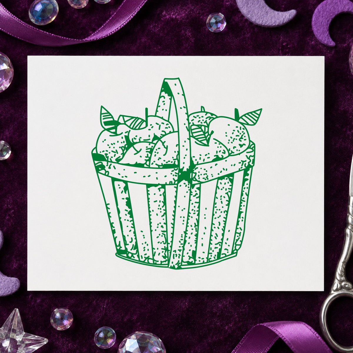 Slatted Apple Basket Rubber Stamp impression in green ink on white paper in a styled craft setting.