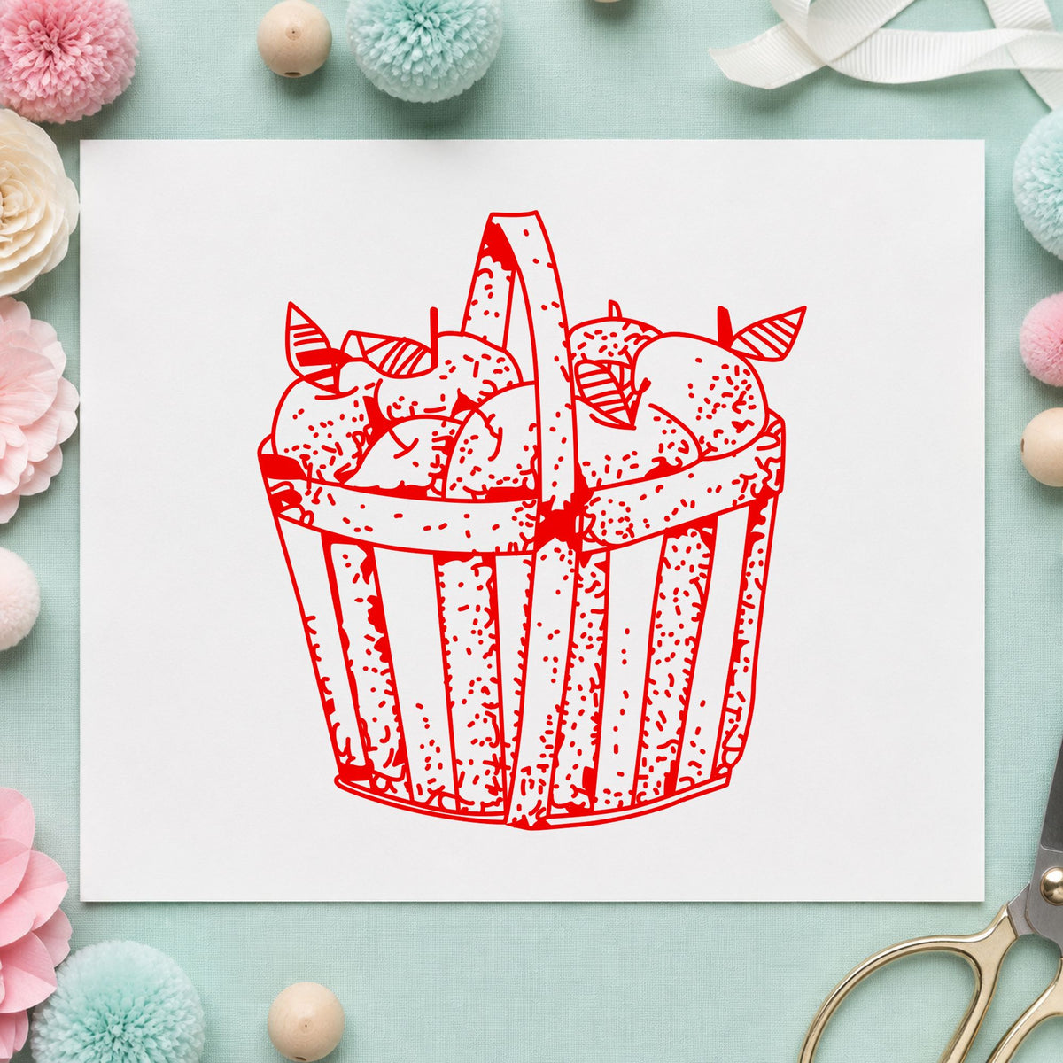 Slatted Apple Basket Rubber Stamp impression in red ink on white paper in a styled craft setting.