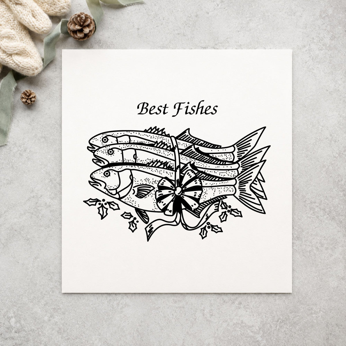 Black impression from a fish rubber stamp, featuring the best fishes with poinsettias design on white paper.