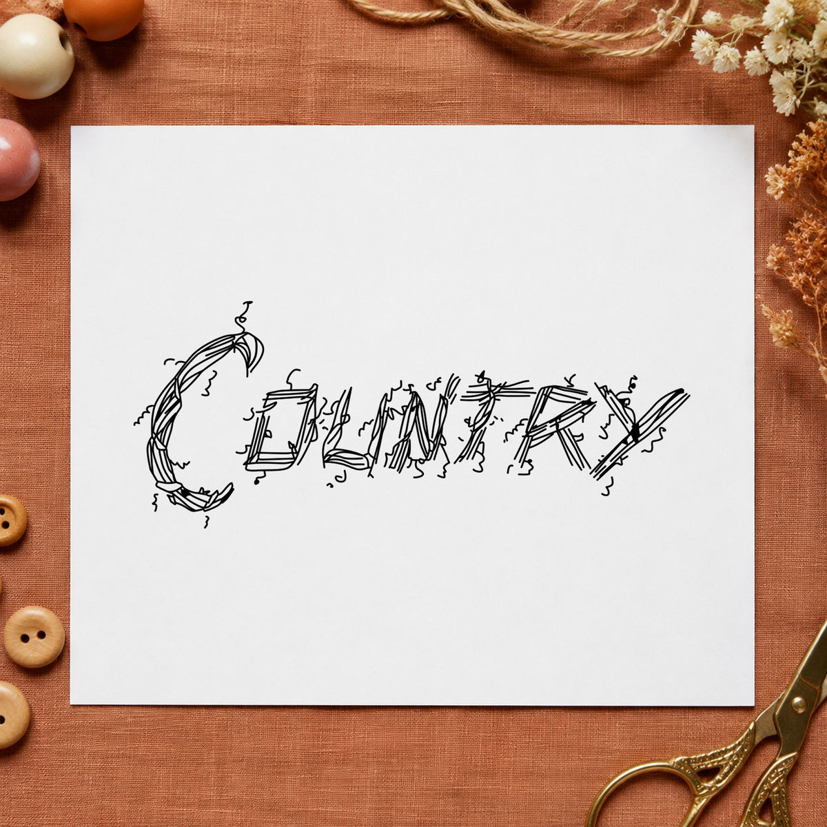 Country Lettering Rubber Stamp impression in black ink on white paper in a styled craft setting.