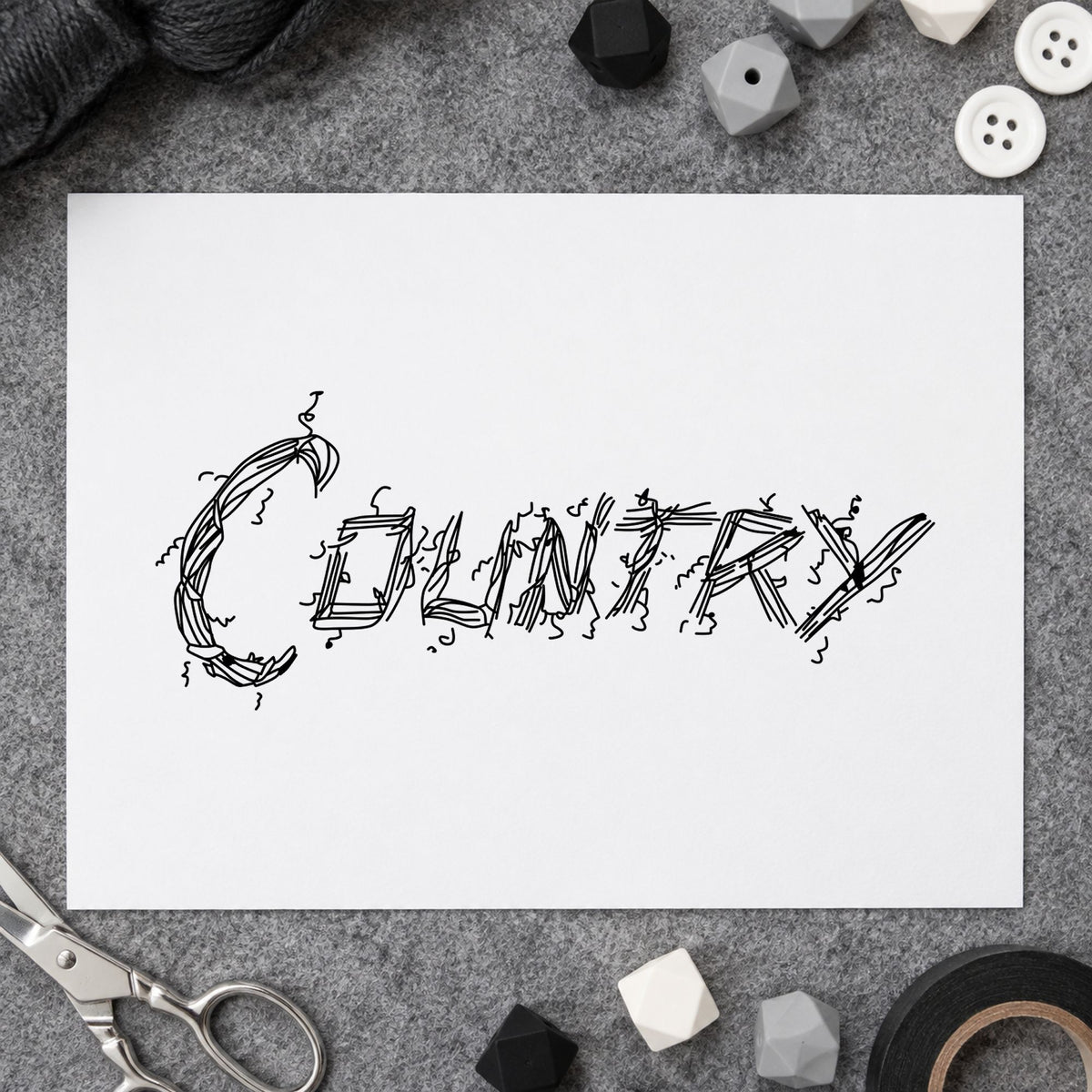 Black impression from a word rubber stamp, featuring the country lettering design on white paper.