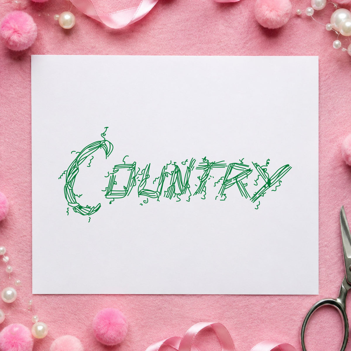 Country Lettering Rubber Stamp impression in green ink on white paper in a styled craft setting.