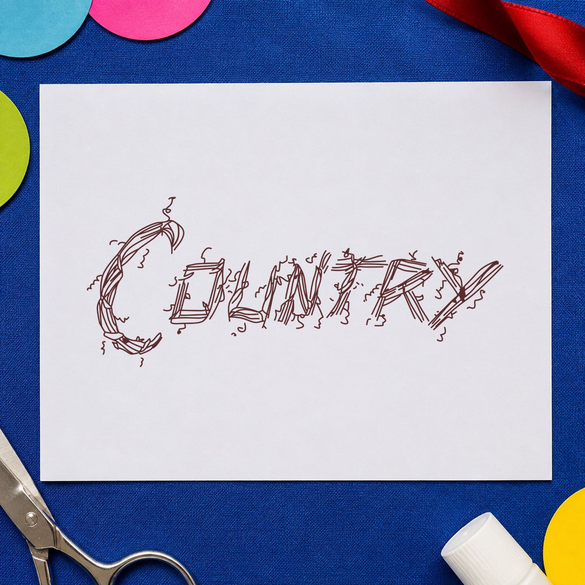 Country Lettering Rubber Stamp impression in brown ink on white paper in a styled craft setting.