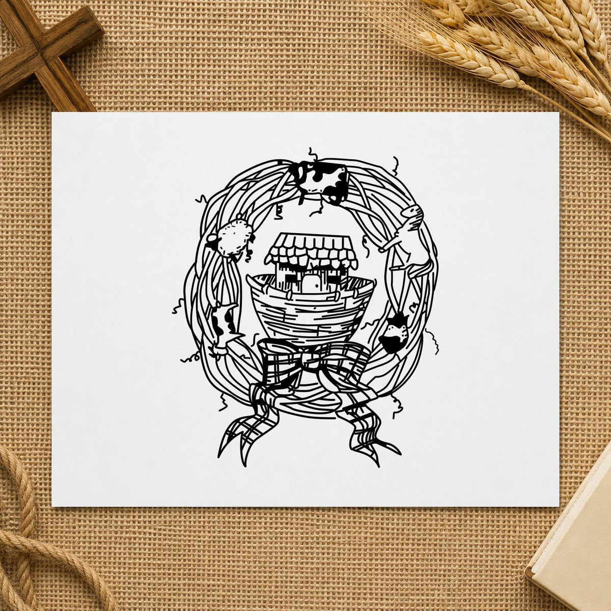 Black impression from a ark rubber stamp, featuring the ark in wreath design on white paper.