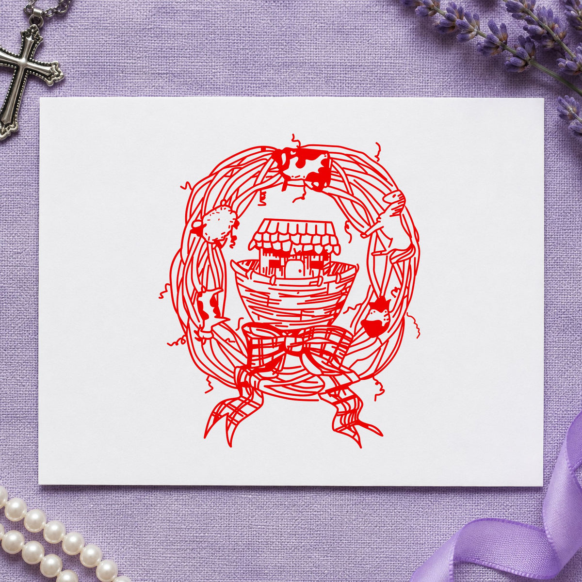 Ark in Wreath Rubber Stamp impression in red ink on white paper in a styled craft setting.