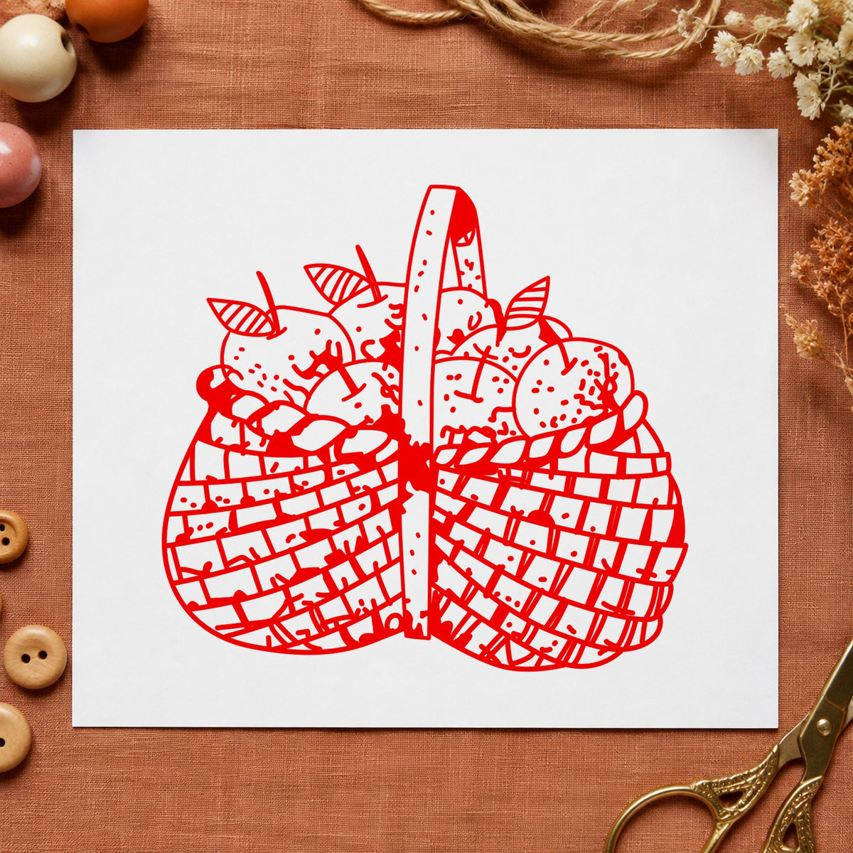 Basket Brimming with Apples Rubber Stamp impression in red ink on white paper in a styled craft setting.