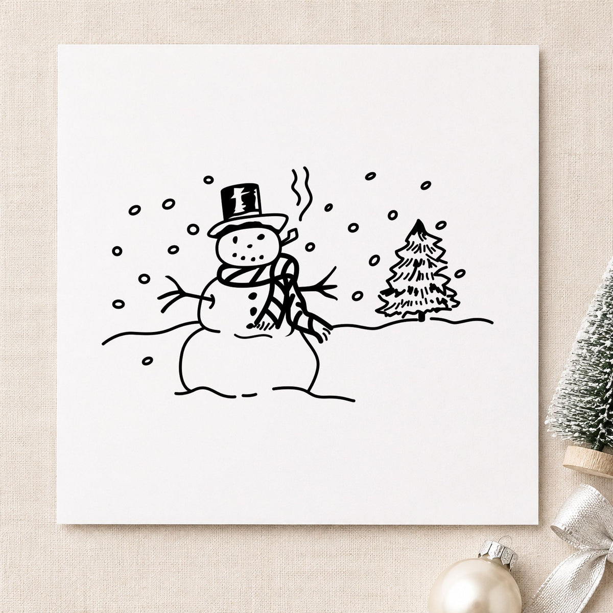 Snowman in Winter Landscape Rubber Stamp impression in black ink on white paper in a styled craft setting.