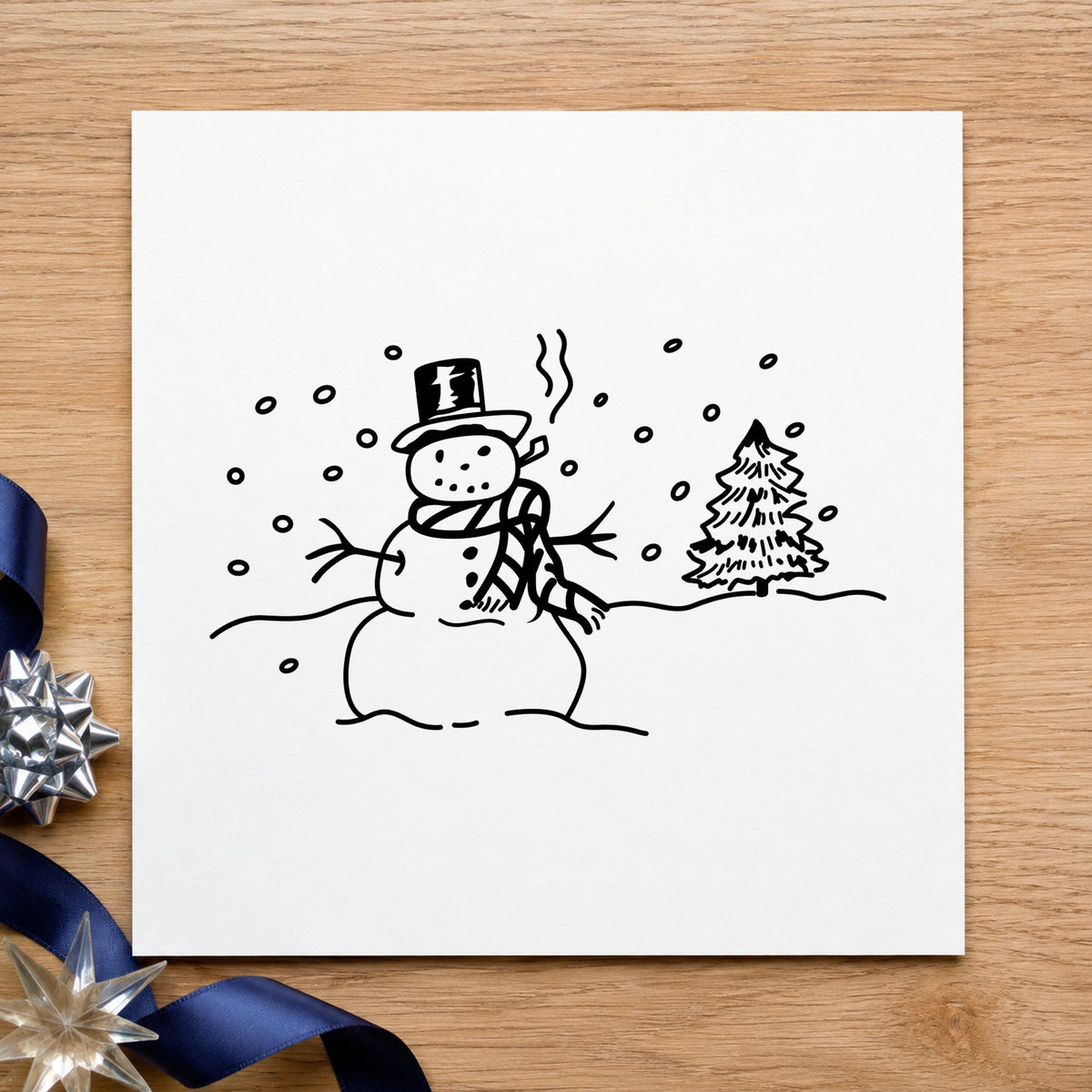 Black impression from a snowman rubber stamp, featuring the snowman in winter landscape design on white paper.