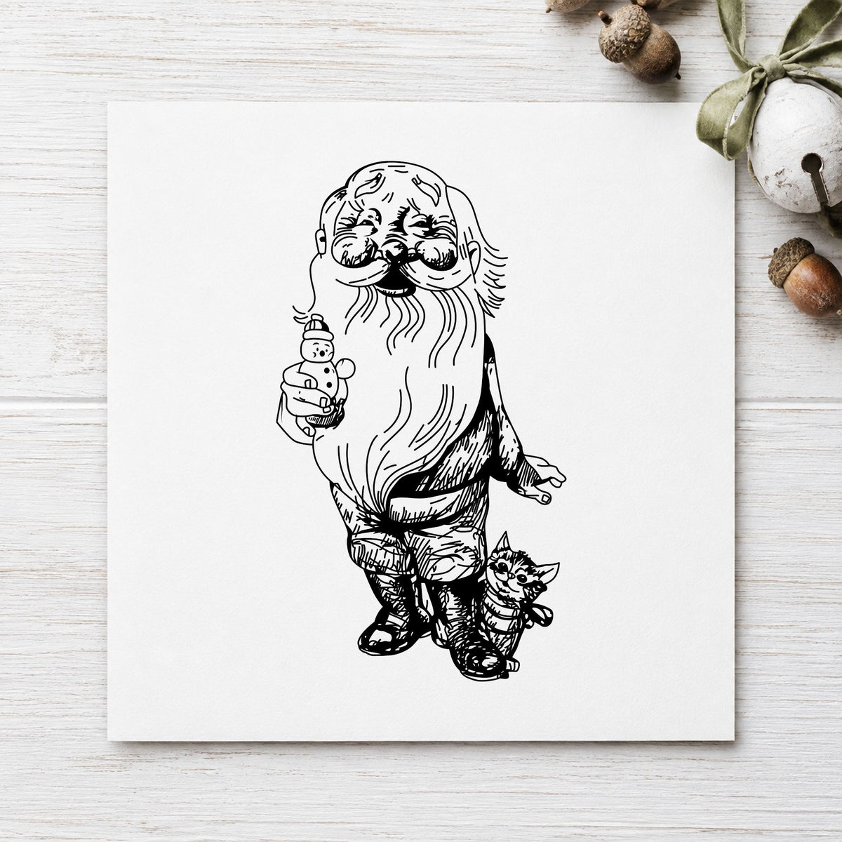 Black impression from a christmas cat stamp, featuring the santa with kitten and snowman design on white paper.