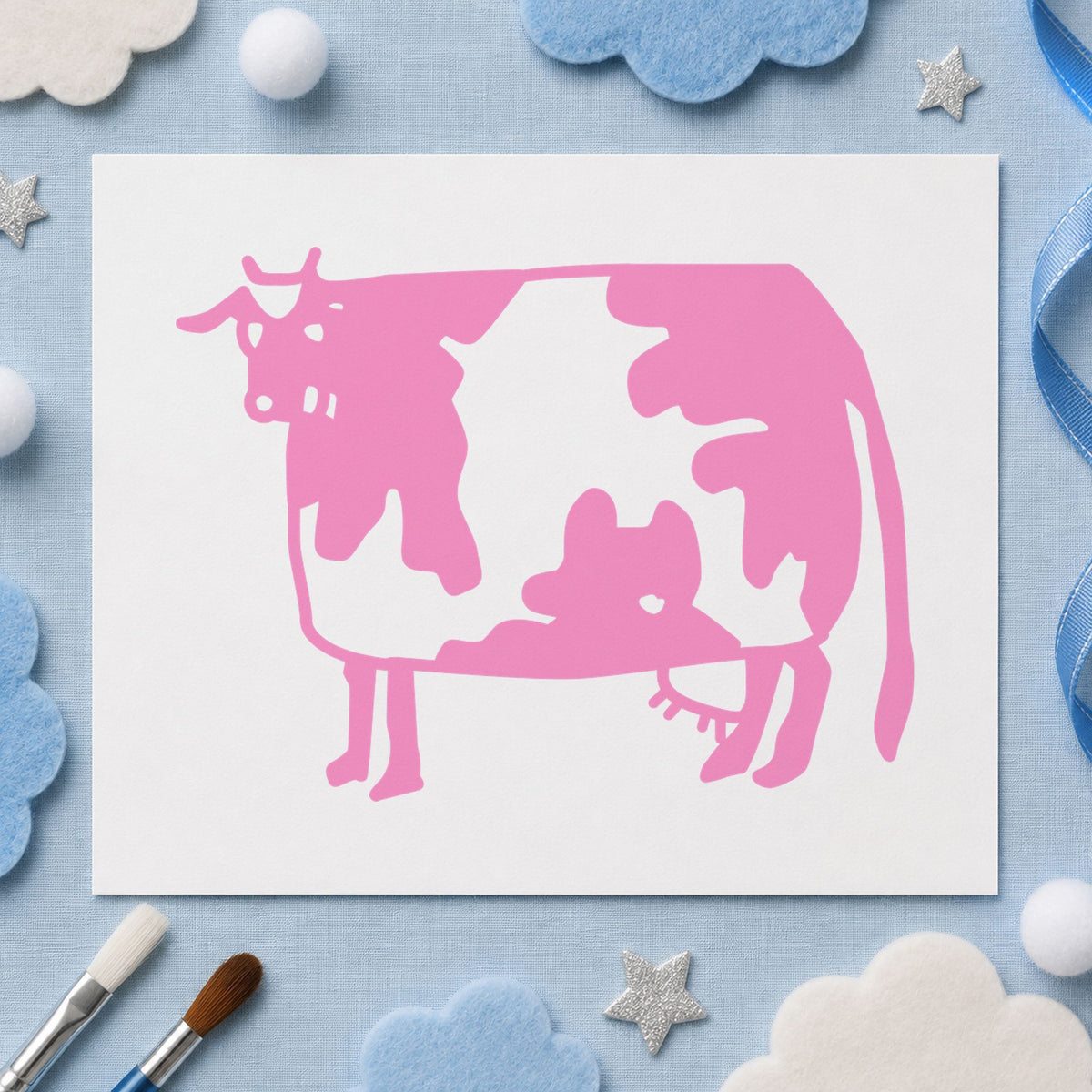 Folk Art Cow Rubber Stamp impression in pink ink on white paper in a styled craft setting.