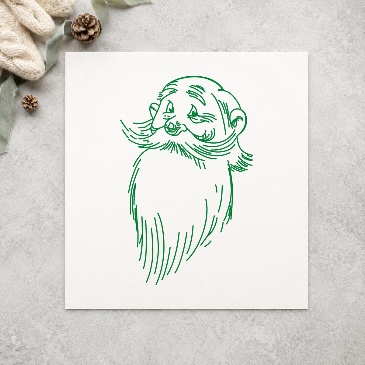 Santa Claus Face Rubber Stamp impression in green ink on white paper in a styled craft setting.
