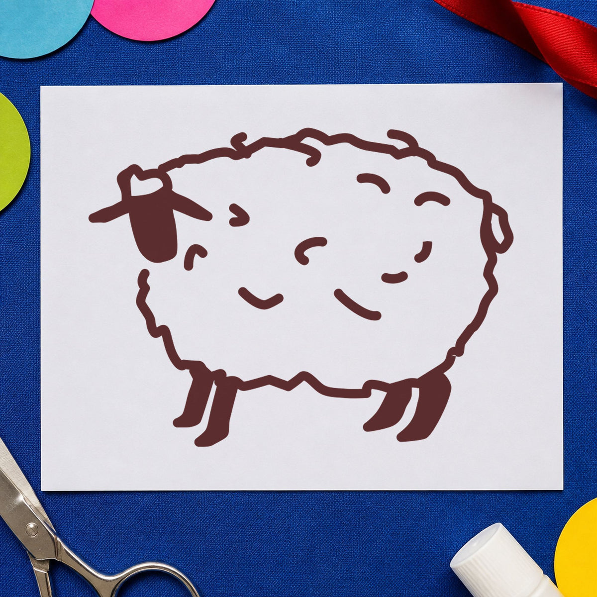 Folk Art Sheep Rubber Stamp impression in brown ink on white paper in a styled craft setting.