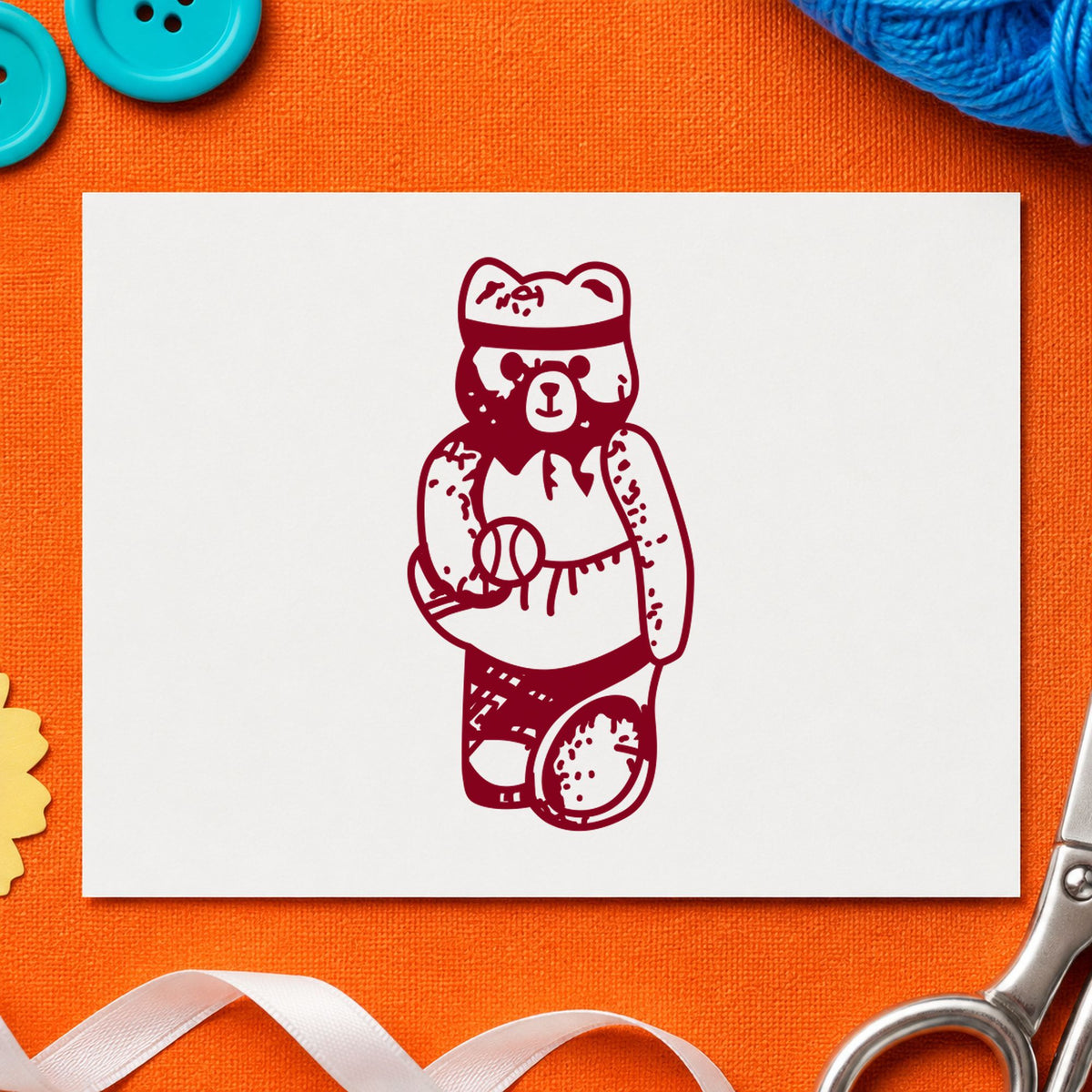 Girl Tennis Bear Rubber Stamp impression in burgundy ink on white paper in a styled craft setting.