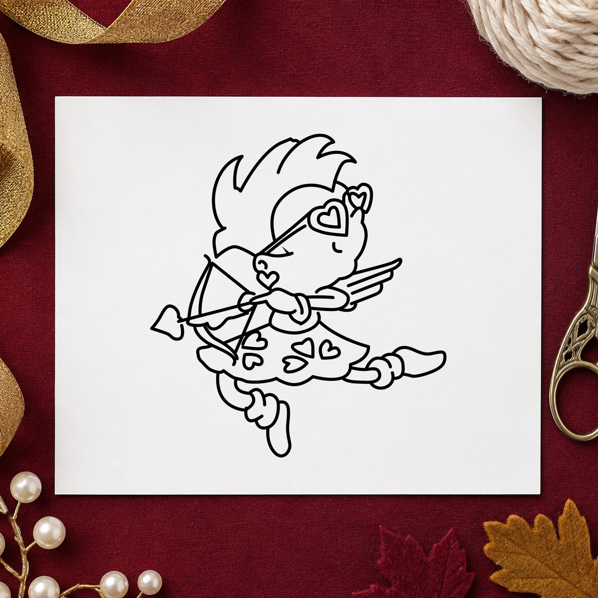 Cupid with Heart Sunglasses Rubber Stamp impression in black ink on white paper in a styled craft setting.
