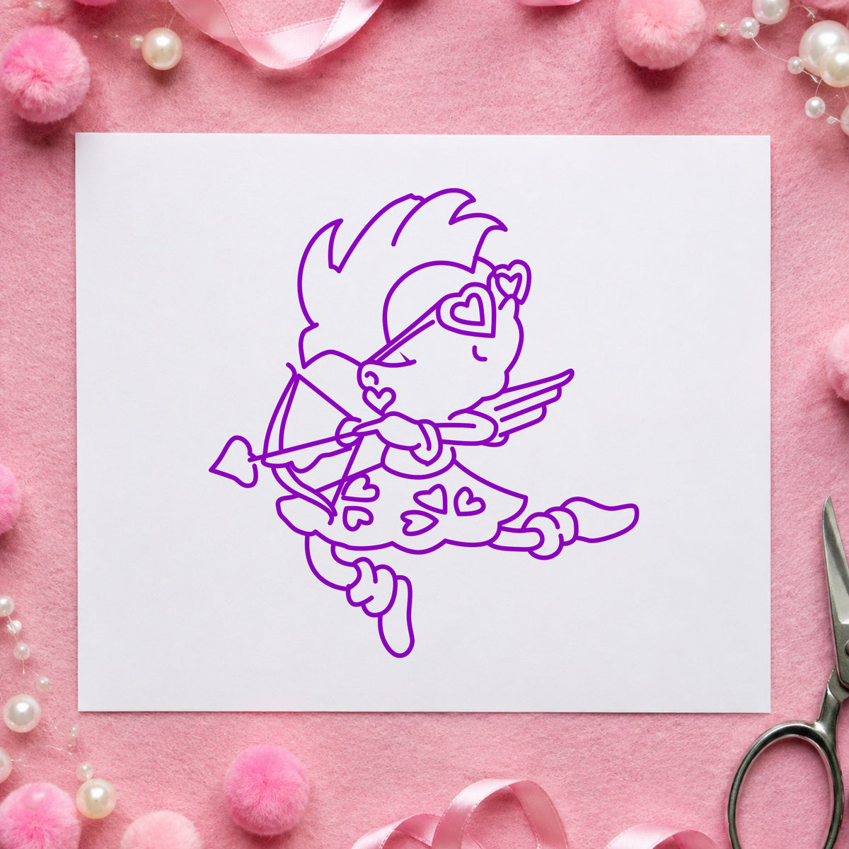 Cupid with Heart Sunglasses Rubber Stamp impression in purple ink on white paper in a styled craft setting.