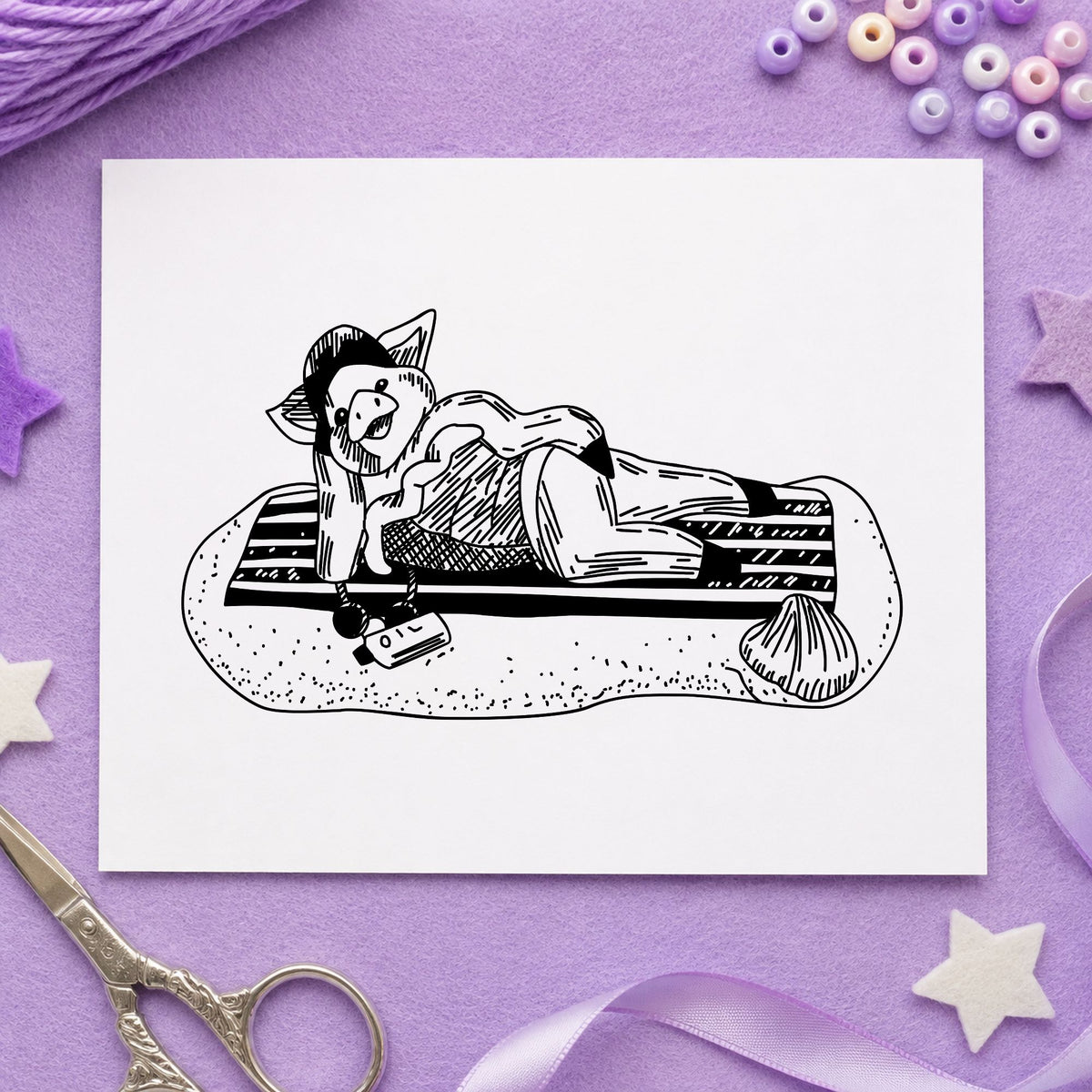 Black impression from a beach pig stamp, featuring the pig on beach blanket design on white paper.