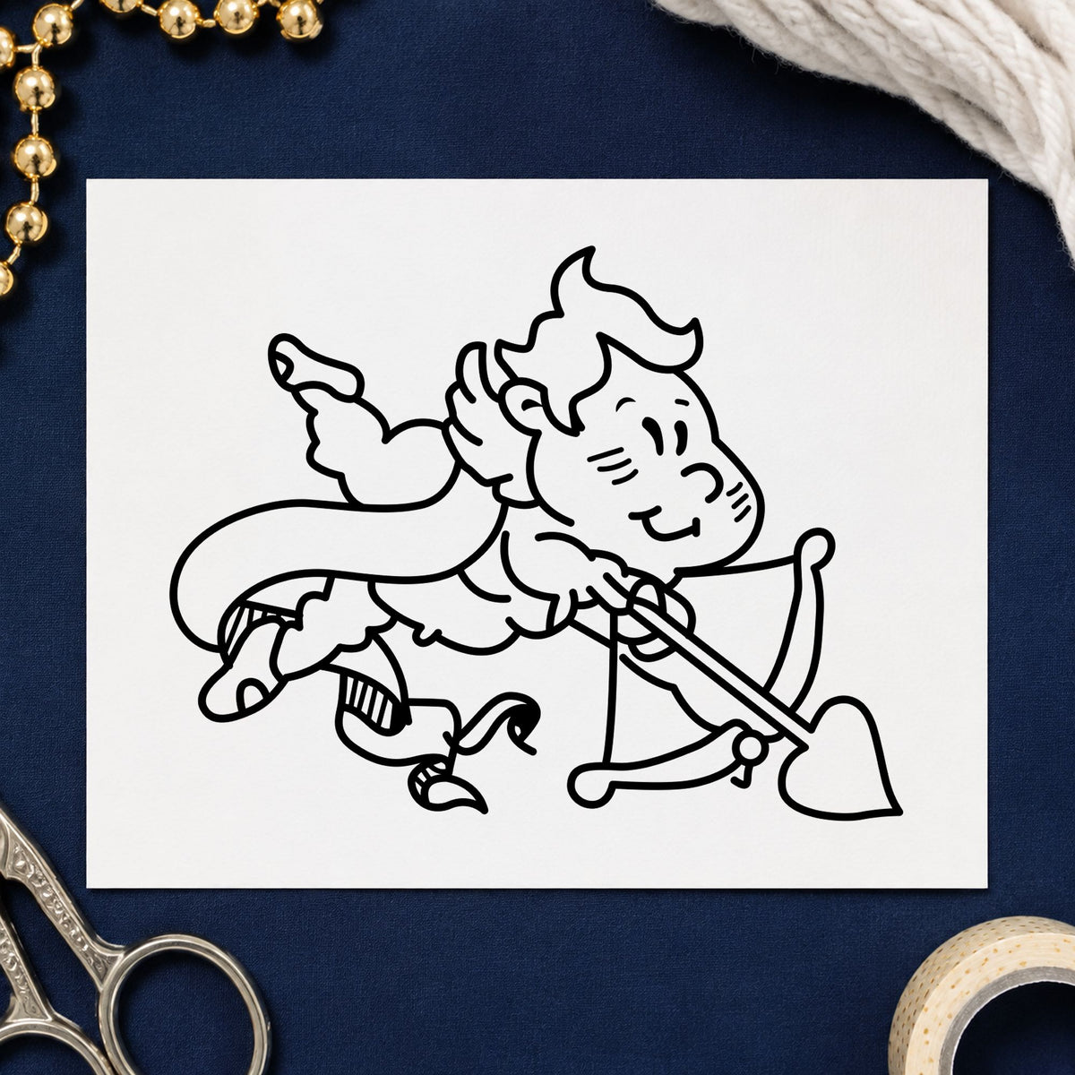 Black impression from a cupid rubber stamp, featuring the cupid shooting heart arrow design on white paper.