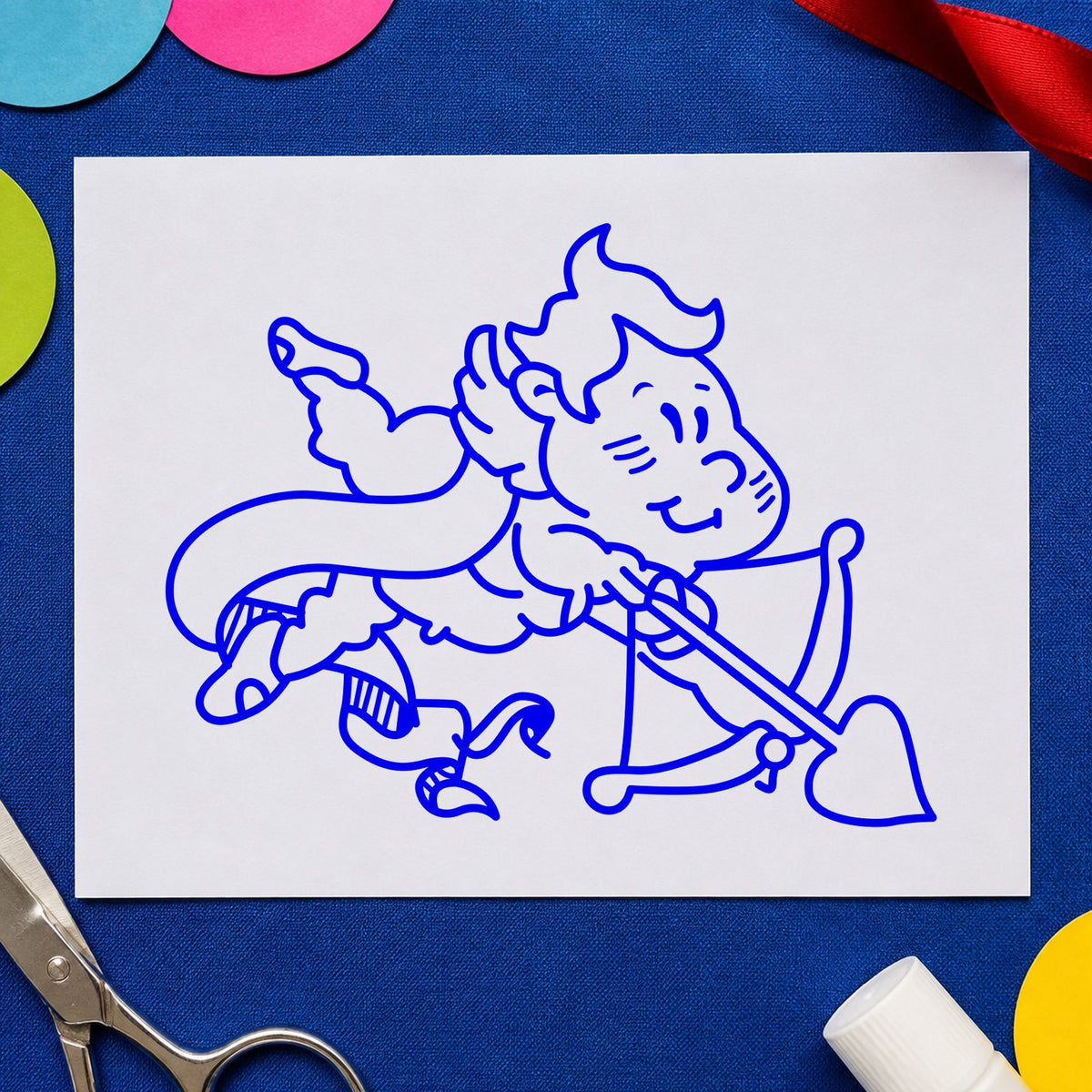 Blue valentine scrapbook stamp impression featuring the cupid shooting heart arrow design on white paper.