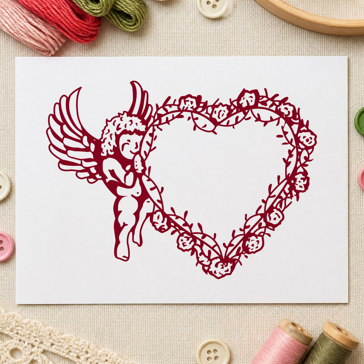 Cupid Holding Vine Heart Rubber Stamp impression in burgundy ink on white paper in a styled craft setting.