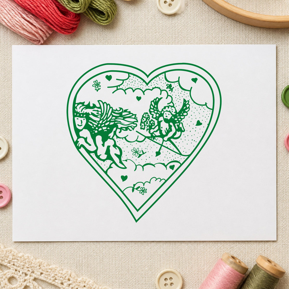 Heart with Two Cupids Rubber Stamp impression in green ink on white paper in a styled craft setting.