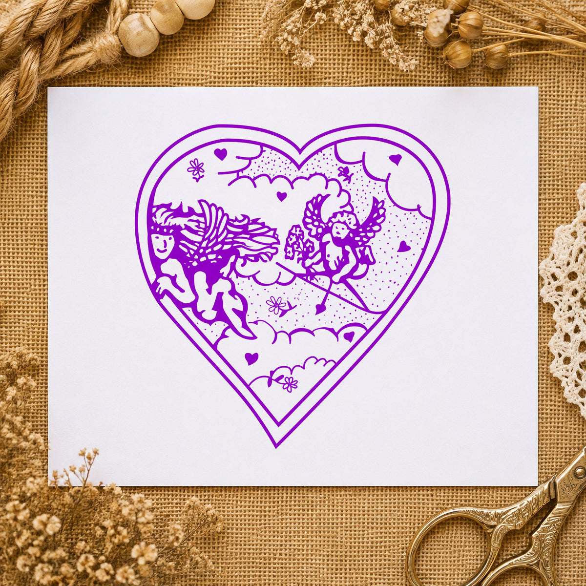 Heart with Two Cupids Rubber Stamp impression in purple ink on white paper in a styled craft setting.