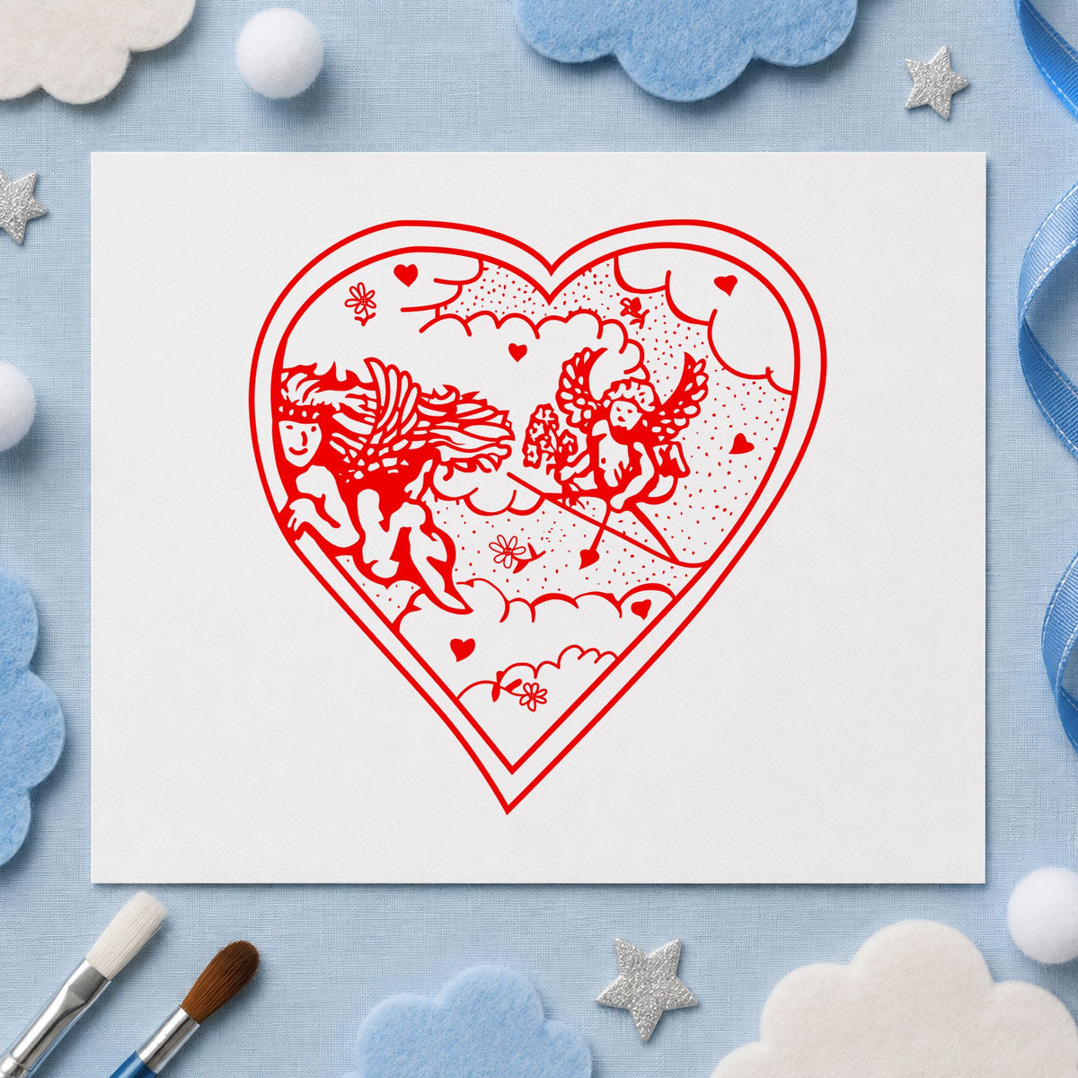 Heart with Two Cupids Rubber Stamp impression in red ink on white paper in a styled craft setting.