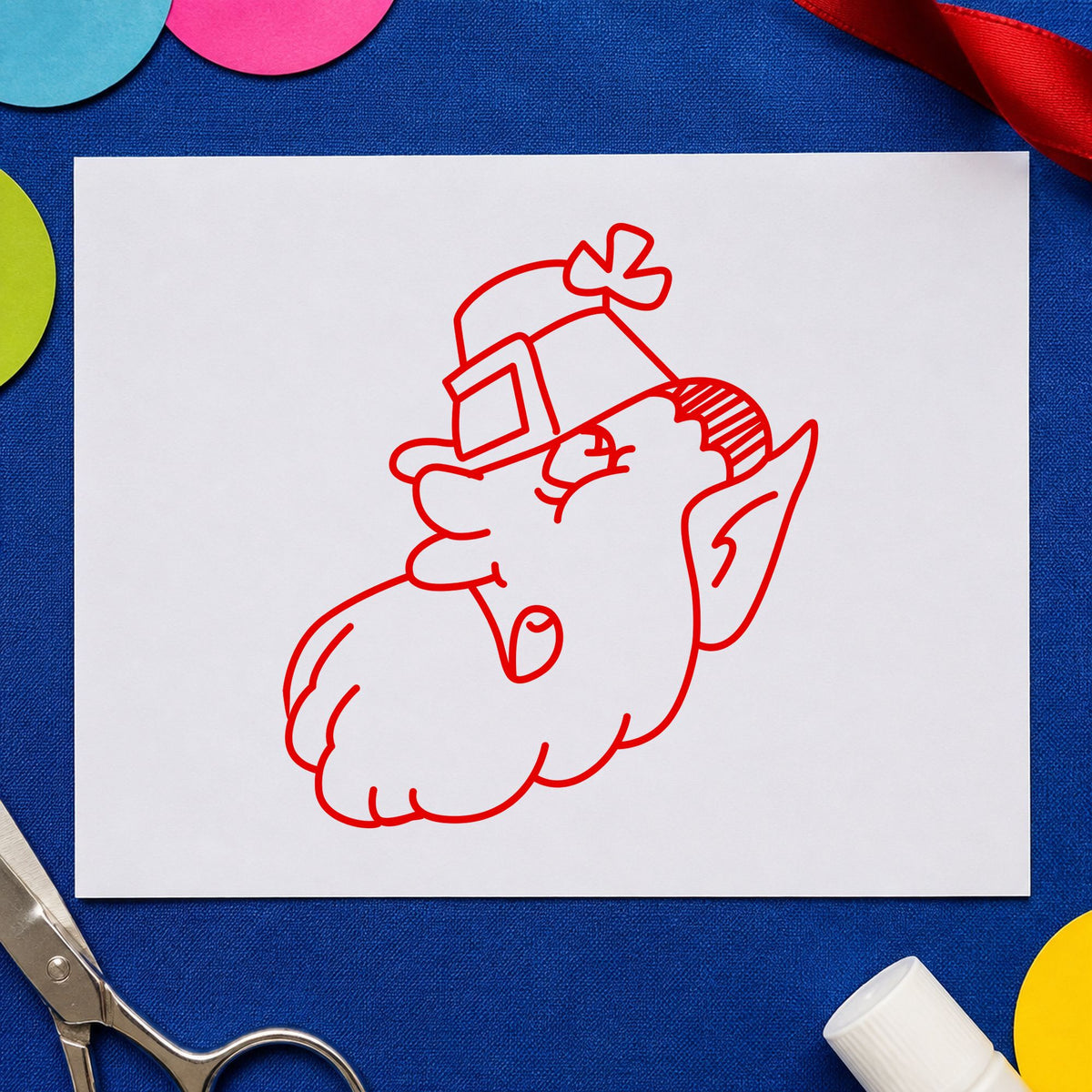 Leprechaun Head with Shamrock Hat Rubber Stamp impression in red ink on white paper in a styled craft setting.