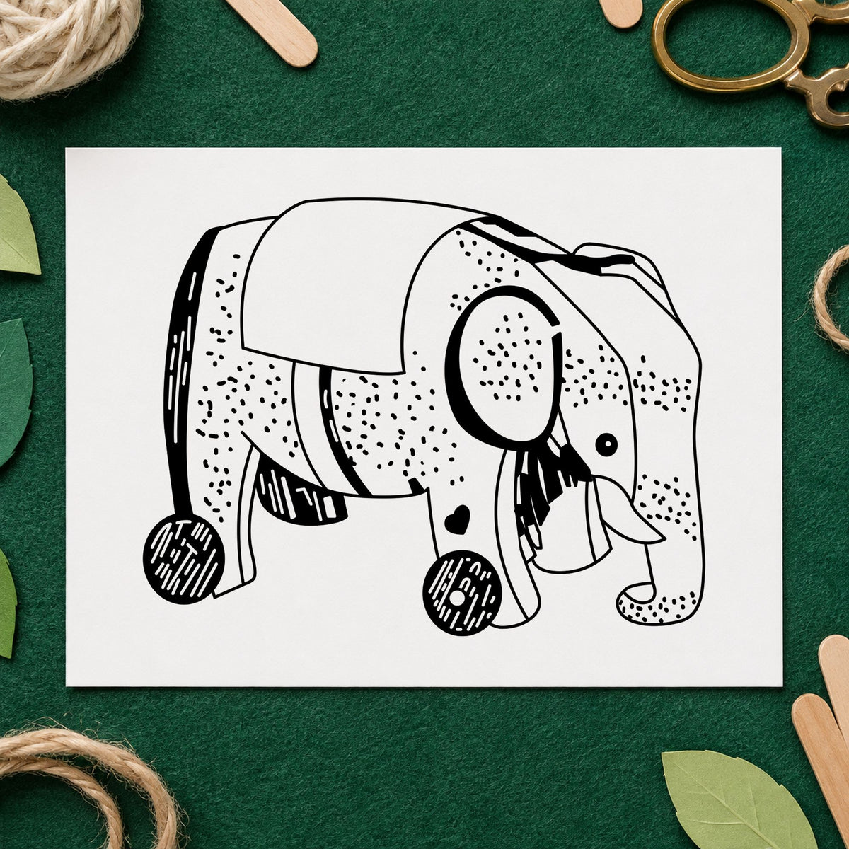Wheeled Elephant Toy Rubber Stamp impression in black ink on white paper in a styled craft setting.