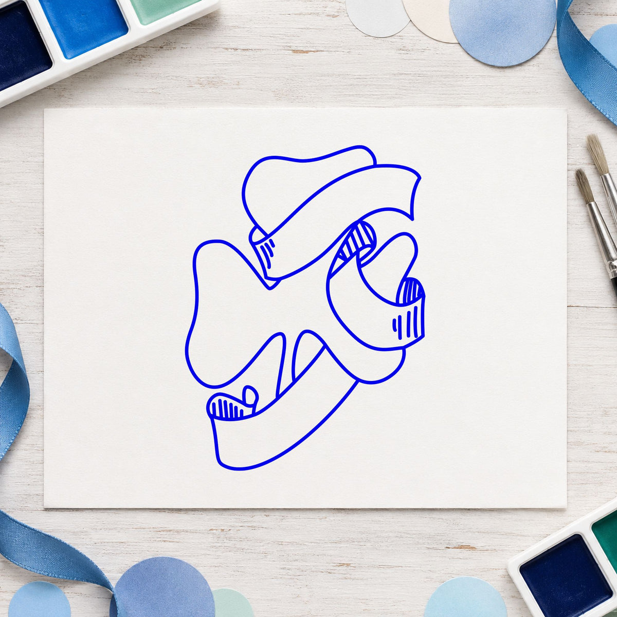 Shamrock with Leprechaun Hat Rubber Stamp impression in blue ink on white paper in a styled craft setting.