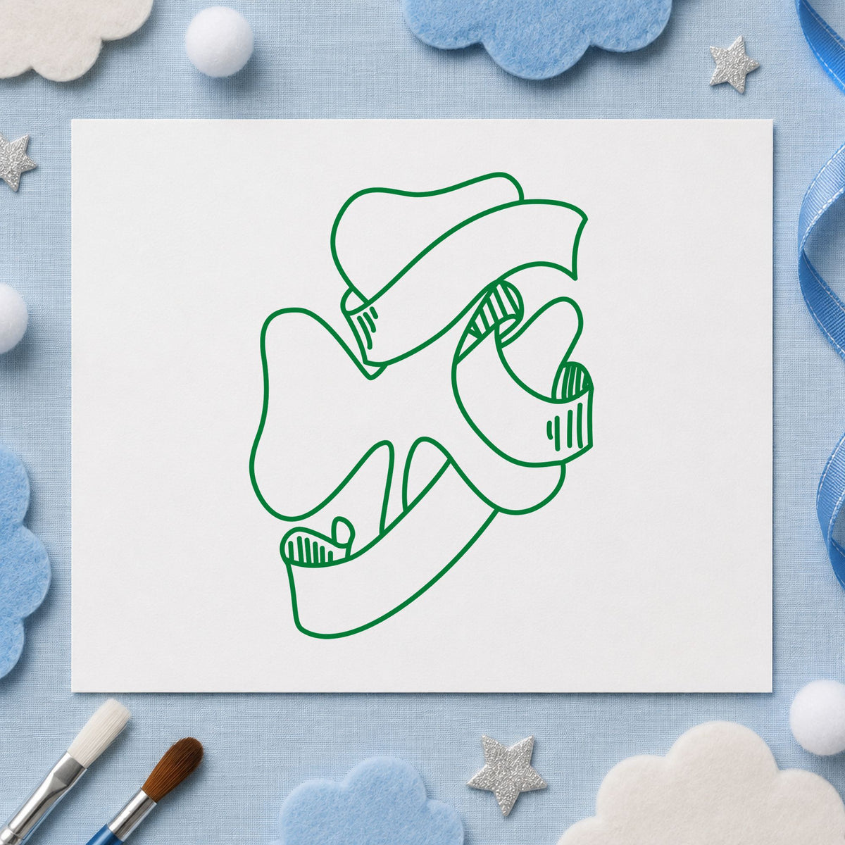 Shamrock with Leprechaun Hat Rubber Stamp impression in green ink on white paper in a styled craft setting.