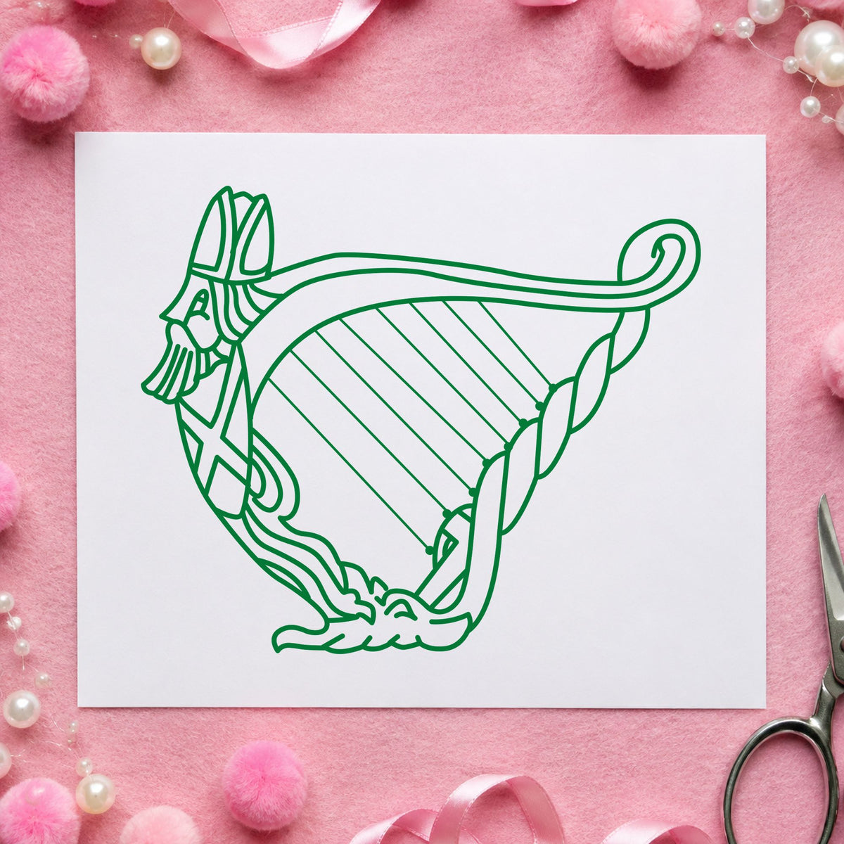 Decorative Harp Rubber Stamp impression in green ink on white paper in a styled craft setting.