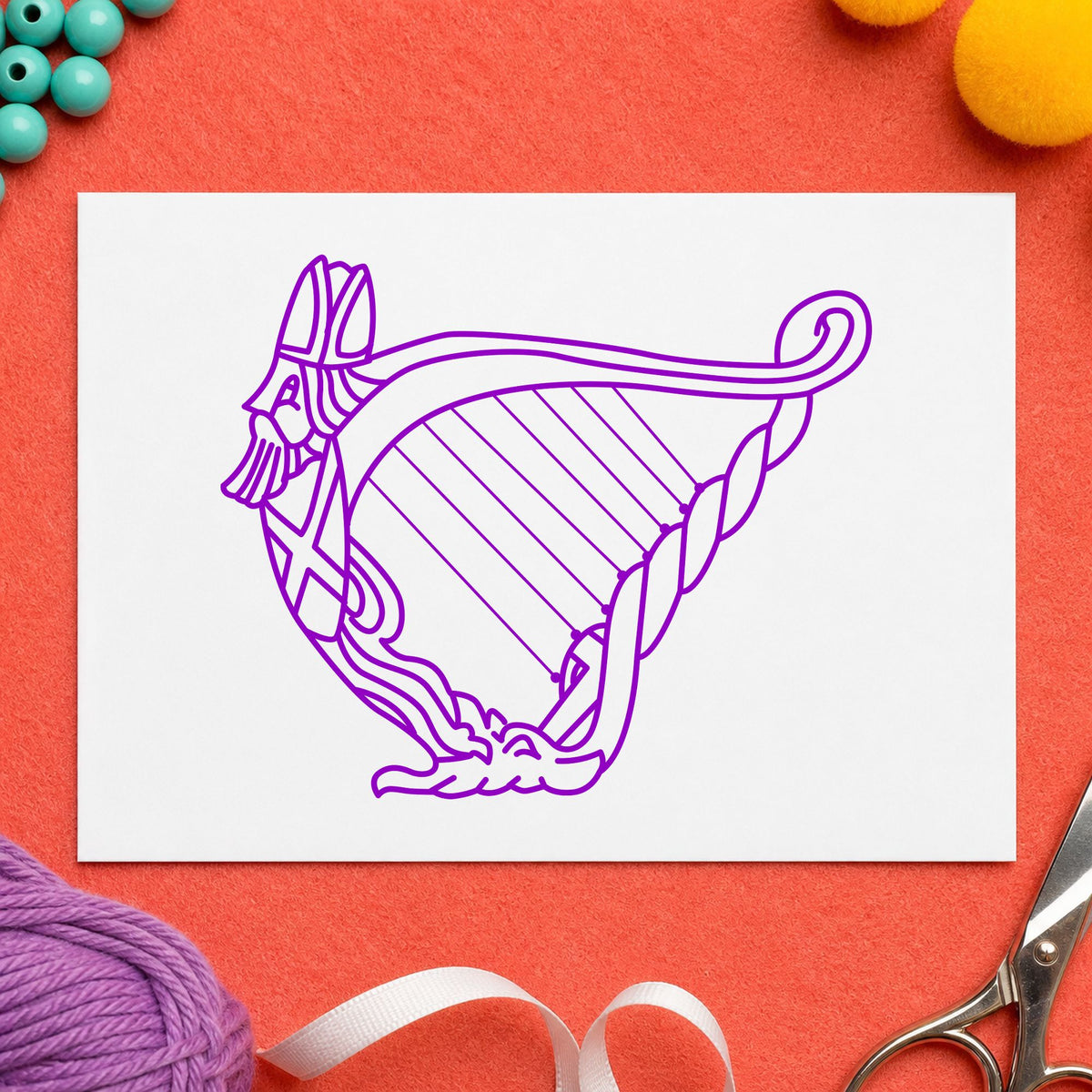 Decorative Harp Rubber Stamp impression in purple ink on white paper in a styled craft setting.