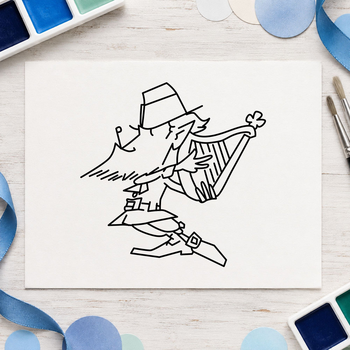 Black impression from a leprechaun rubber stamp, featuring the leprechaun playing harp design on white paper.
