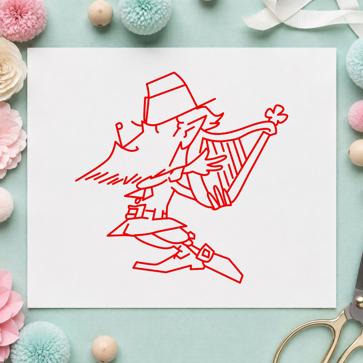 Leprechaun Playing Harp Rubber Stamp impression in red ink on white paper in a styled craft setting.
