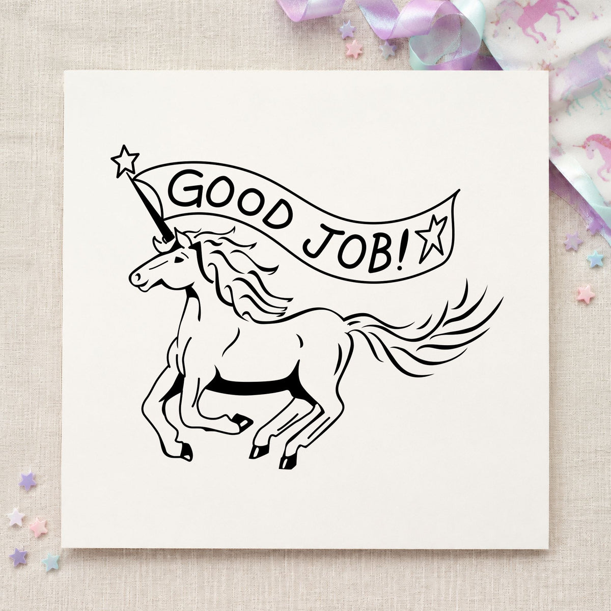 Good Job Unicorn Rubber Stamp impression in black ink on white paper in a styled craft setting.