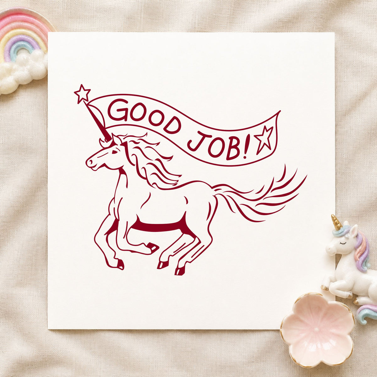 Good Job Unicorn Rubber Stamp impression in burgundy ink on white paper in a styled craft setting.