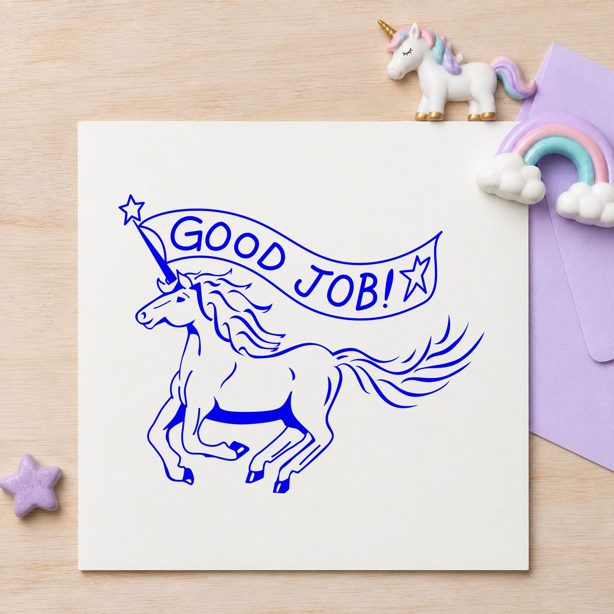 Blue teacher praise stamp impression featuring the good job unicorn design on white paper.