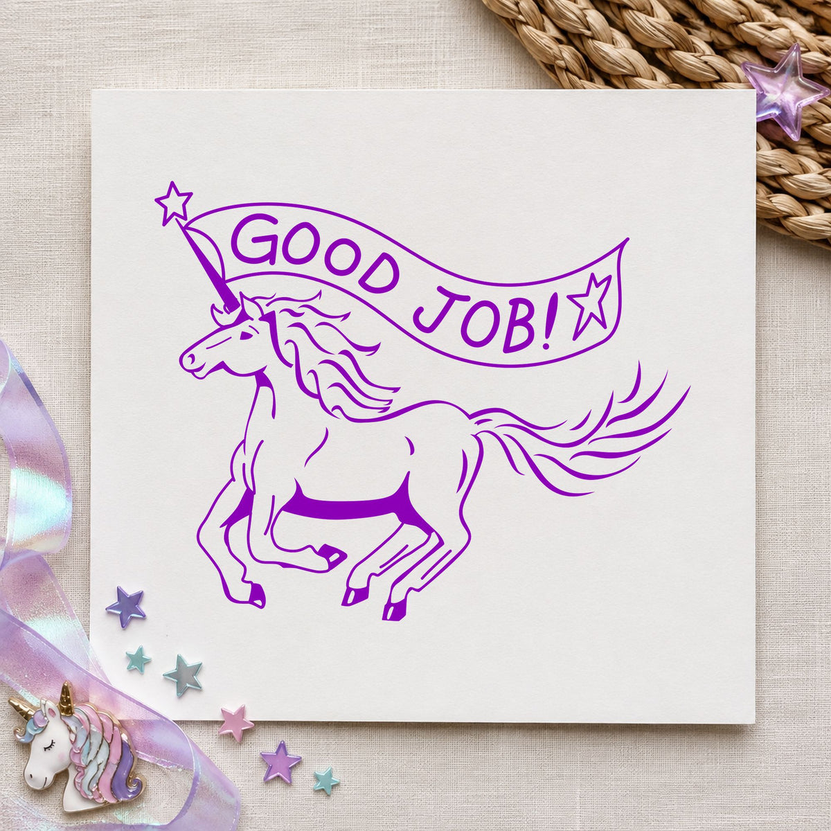 Good Job Unicorn Rubber Stamp impression in purple ink on white paper in a styled craft setting.