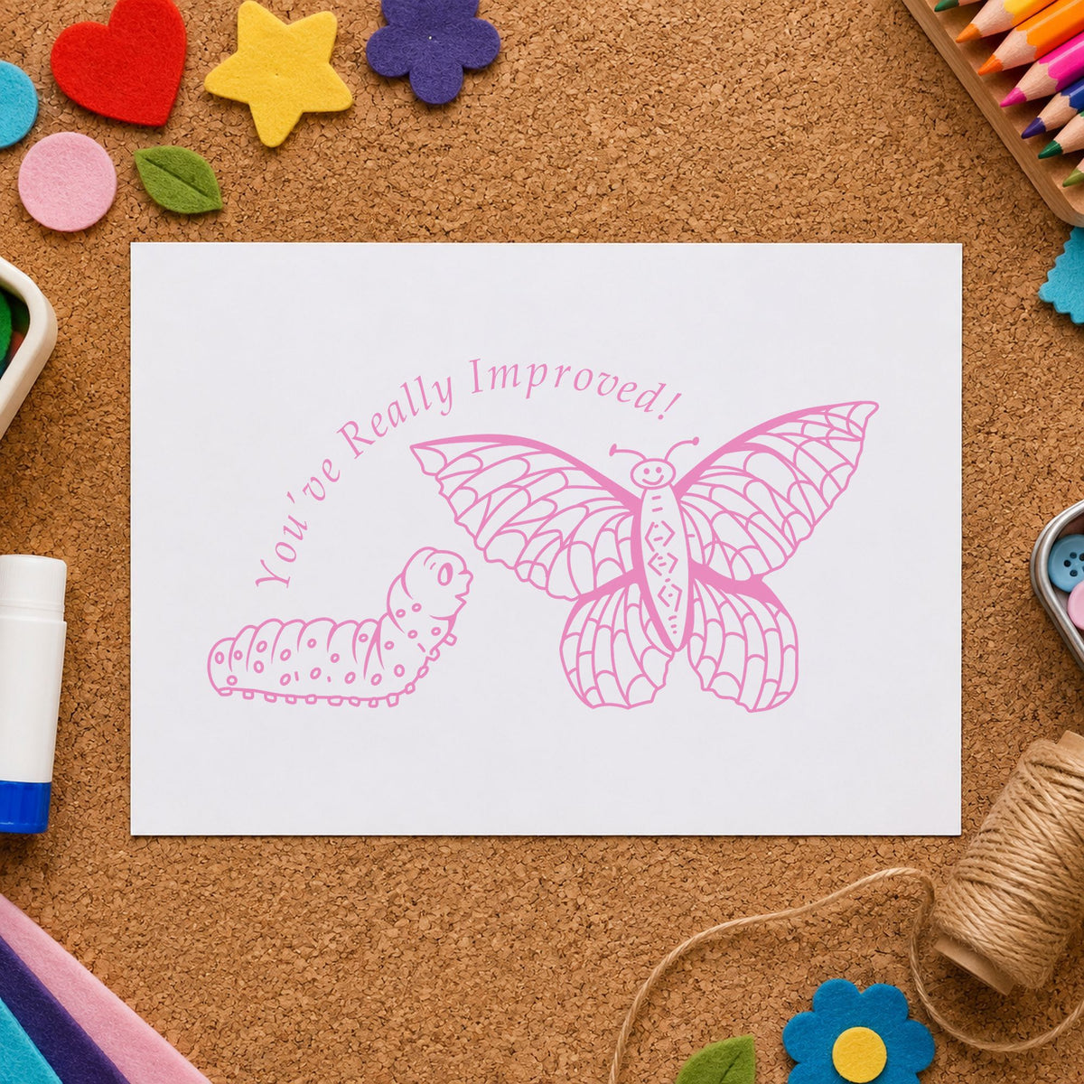 Youve Really Improved Butterfly and Caterpillar Rubber Stamp impression in pink ink on white paper in a styled craft setting.