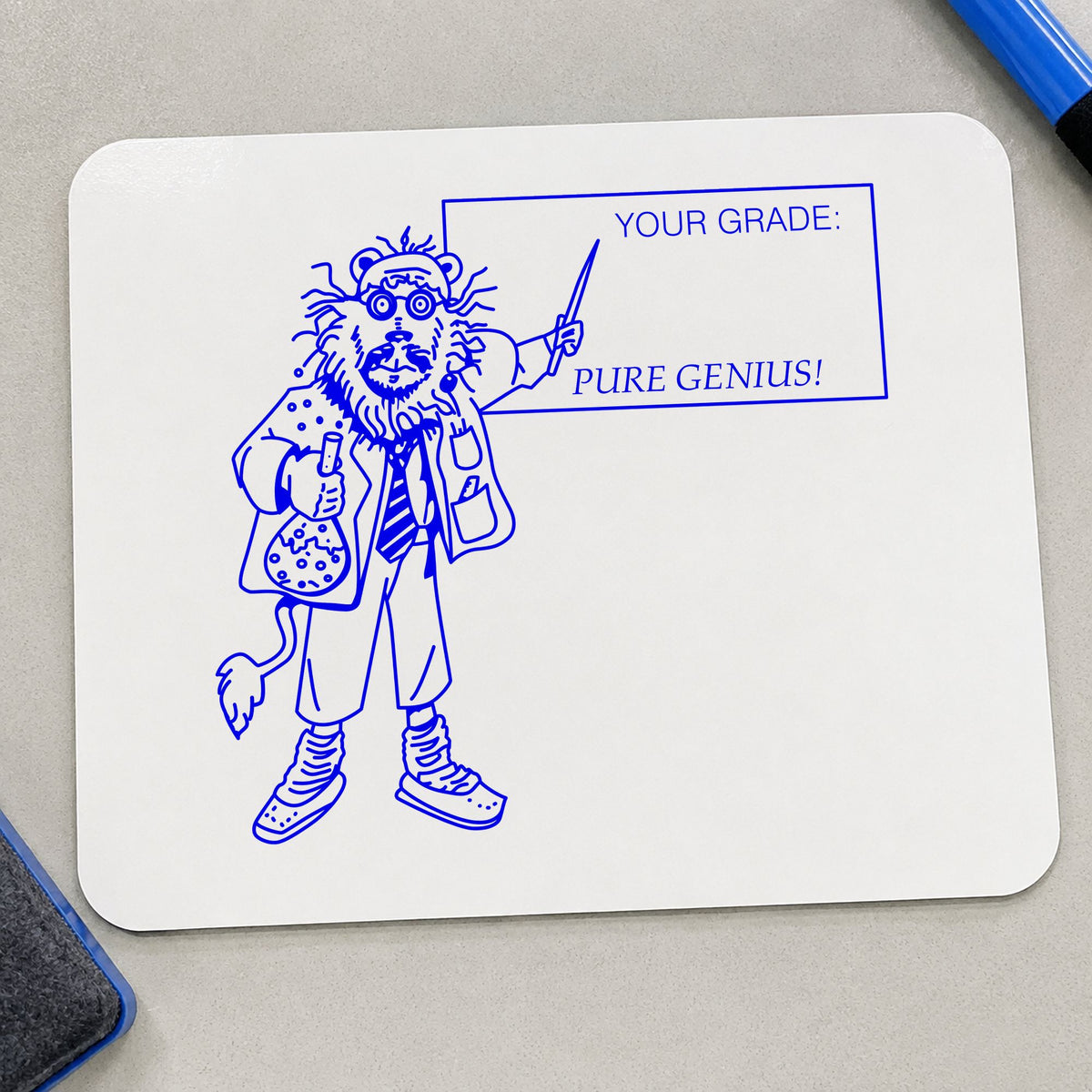 Your Grade Pure Genius Lion Rubber Stamp impression in blue ink on white paper in a styled craft setting.