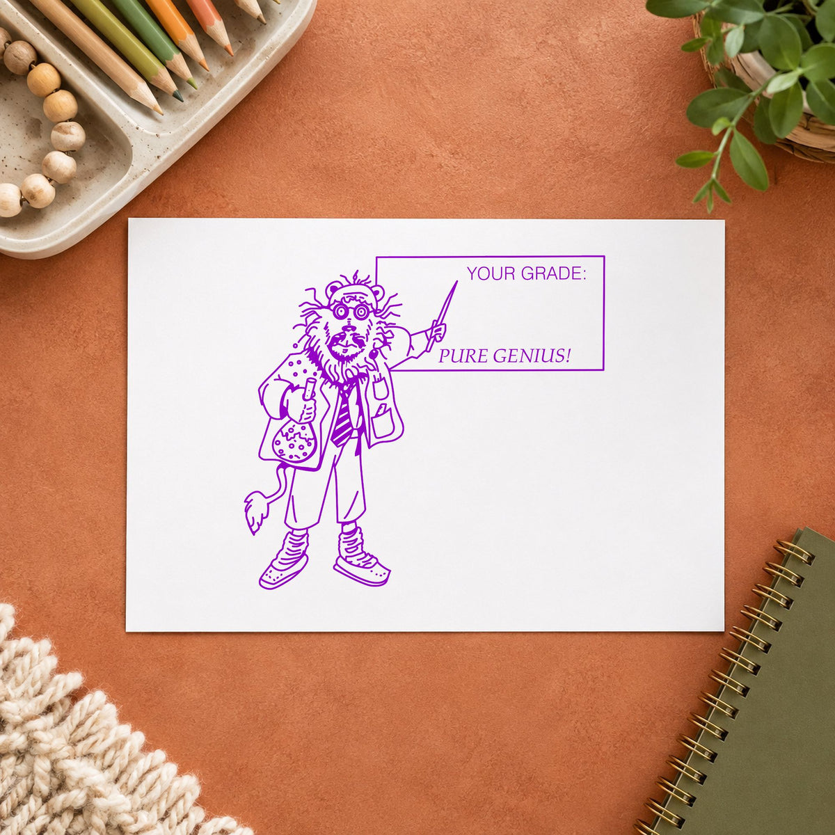 Your Grade Pure Genius Lion Rubber Stamp impression in purple ink on white paper in a styled craft setting.