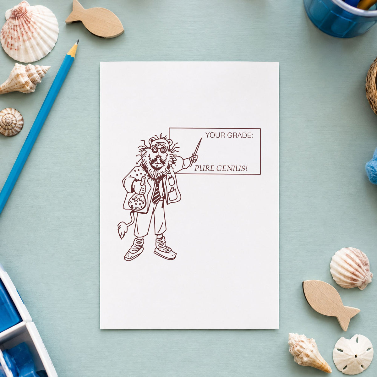 Your Grade Pure Genius Lion Rubber Stamp impression in brown ink on white paper in a styled craft setting.