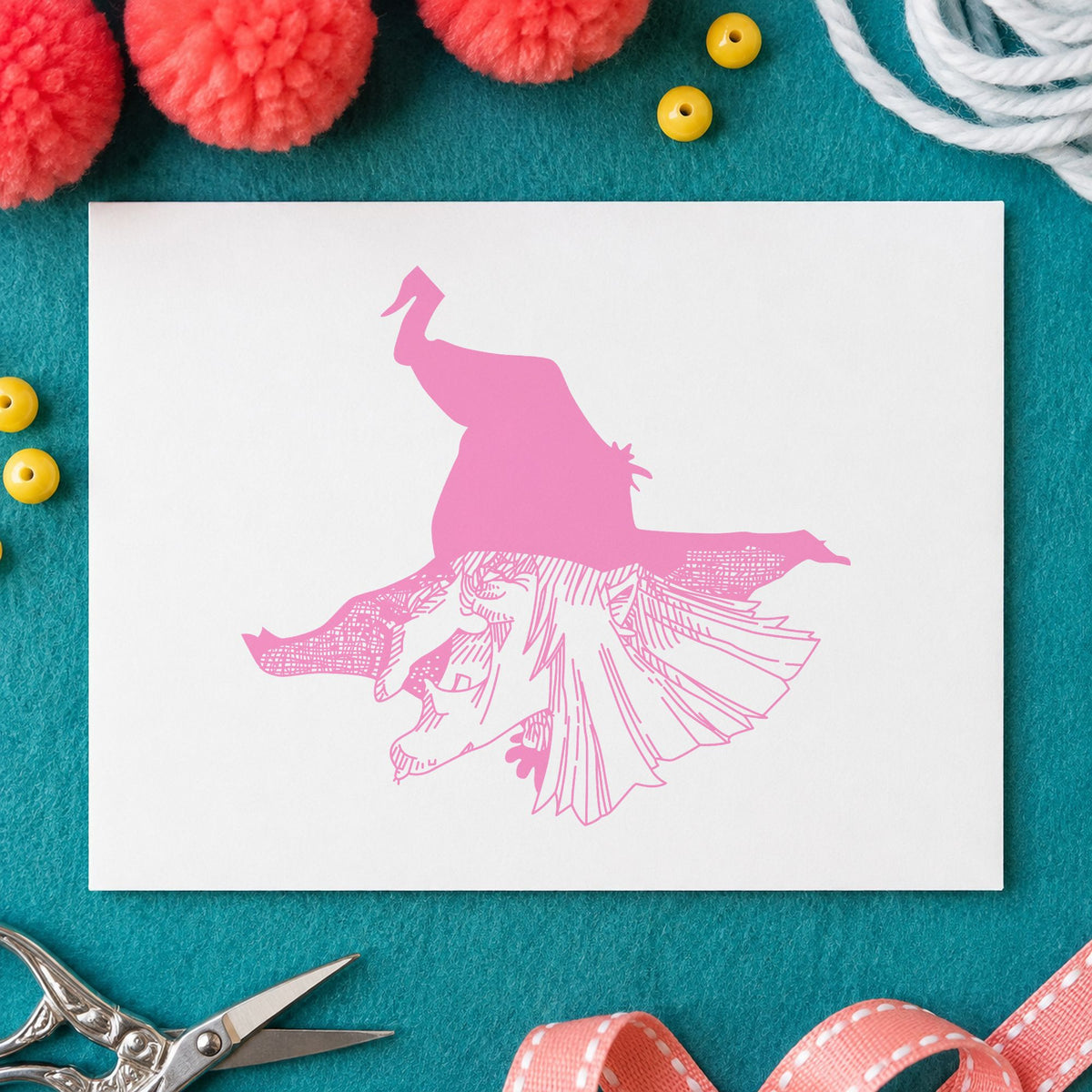 Witch Head with Hat Rubber Stamp impression in pink ink on white paper in a styled craft setting.