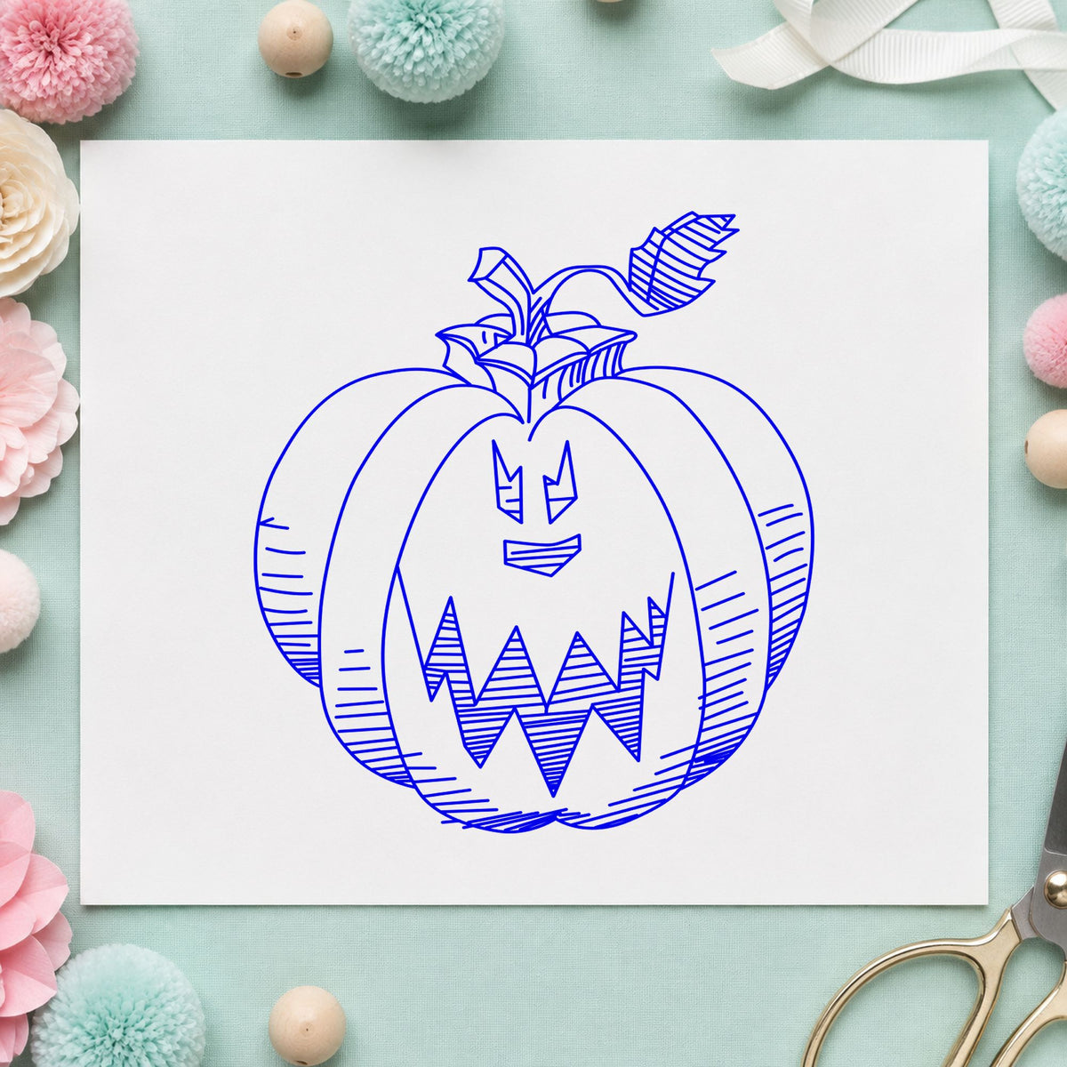 Blue halloween scrapbook stamp impression featuring the scary pumpkin face design on white paper.