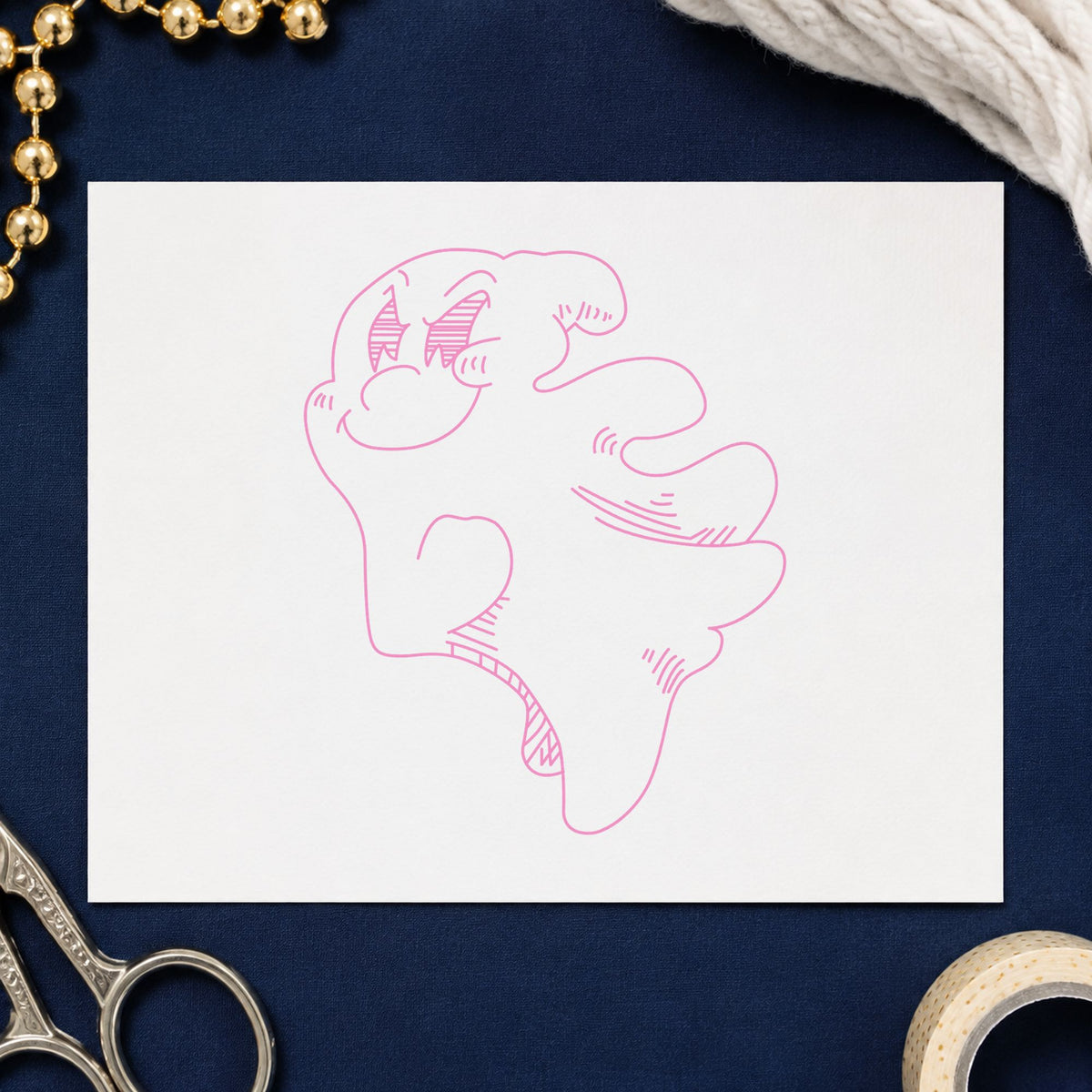 Friendly Smiling Ghost Rubber Stamp impression in pink ink on white paper in a styled craft setting.