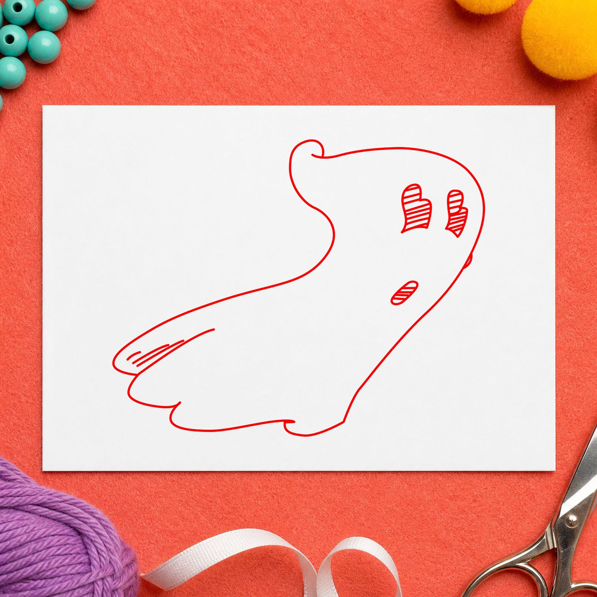 Spooky Ghost Rubber Stamp impression in red ink on white paper in a styled craft setting.