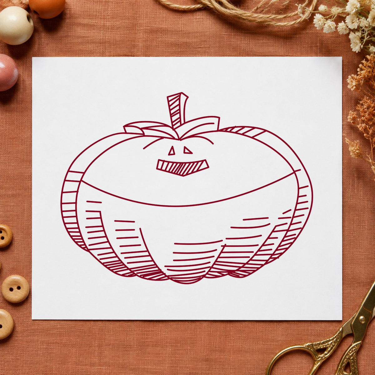 Smiling Jacko Lantern Rubber Stamp impression in burgundy ink on white paper in a styled craft setting.