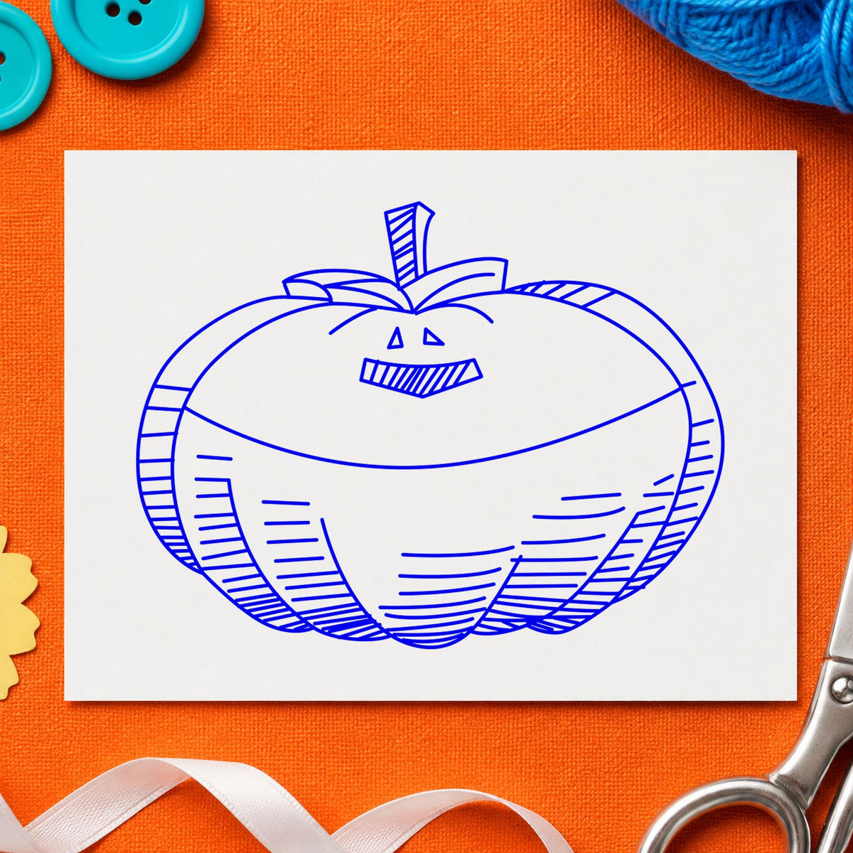 Blue halloween card making stamp impression featuring the smiling jacko lantern design on white paper.