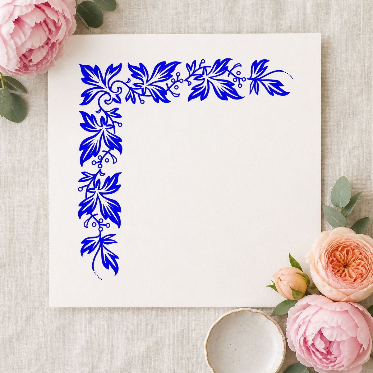 Semi Solid Leaf Corner Rubber Stamp impression in blue ink on white paper in a styled craft setting.