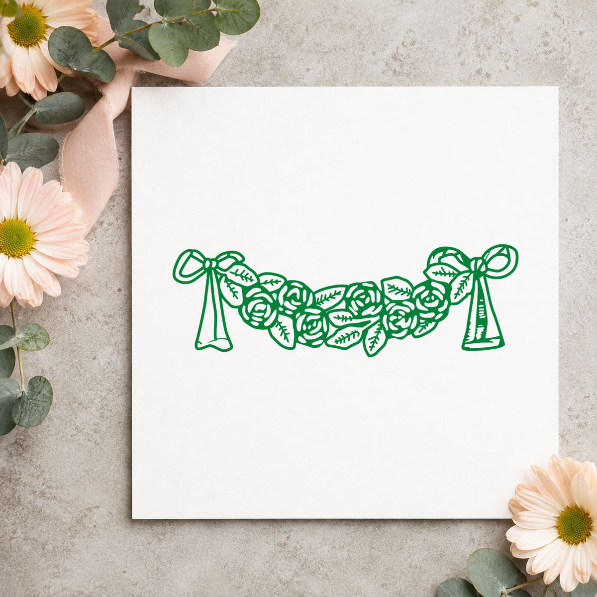 Rose Swag with Bows Rubber Stamp impression in green ink on white paper in a styled craft setting.